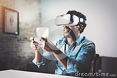 Concept of technology,gaming,entertainment and people.African man enjoying virtual reality glasses while relaxing in Stock Photo