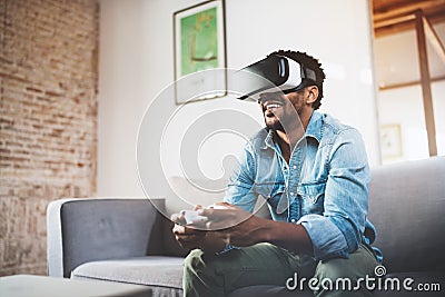 Concept of technology,gaming,entertainment and people.Happy african man enjoying virtual reality glasses while relaxing Stock Photo
