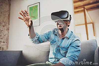 Concept of technology,gaming,entertainment and people.Happy bearded african man enjoying virtual reality glasses while Stock Photo