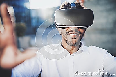 Concept of technology,gaming,entertainment and young people.Smiling american african man enjoying virtual reality Stock Photo