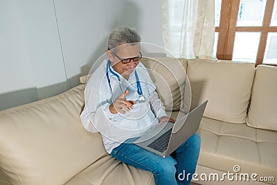 Concept of telehealth: a doctor in front of a computer and talking to a patient Stock Photo