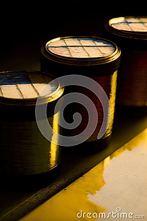 Three Spools Of Thread Sitting Next To Each Other. Generative AI Stock Photo