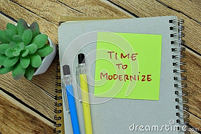 Concept of Time to Modernize write on sticky notes isolated on Wooden Table Stock Photo