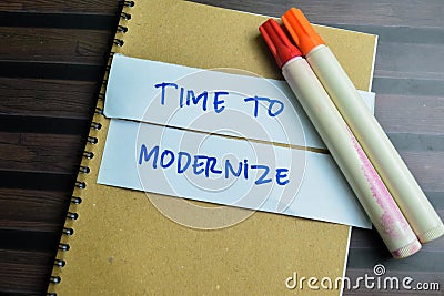 Concept of Time To Modernize write on sticky notes isolated on Wooden Table Stock Photo