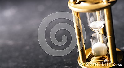 Concept timekeeping. Sand trickles through an hourglass Stock Photo