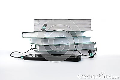 Concept to listen to audiobooks. Blue headphones and smatphone near stack of books Stock Photo