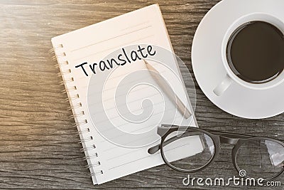 Concept Translate on notebook with glasses, pencil and coffee cu Stock Photo