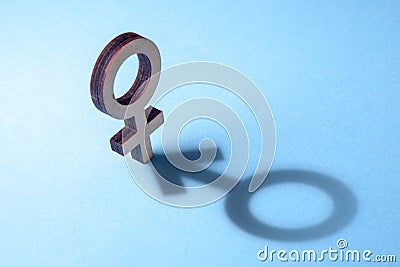 Concept of transvestite or bisexual. Tranender, woman feels like man. Shadow of woman`s gerner symbol in the form of symbol of man Stock Photo