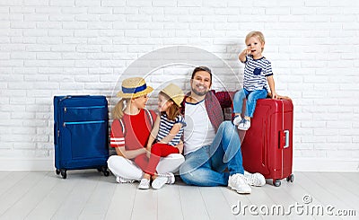 Concept travel and tourism. happy family with suitcases near w Stock Photo