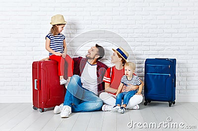 Concept travel and tourism. happy family with suitcases near w Stock Photo