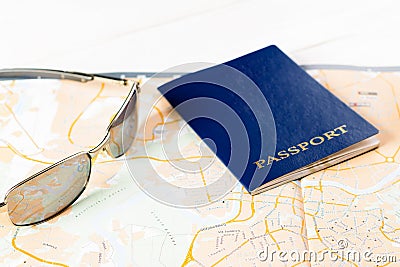 Concept of travelling, shopping, vacation, rest and relax. Selective focus on passport and sunglasses laying on map Stock Photo