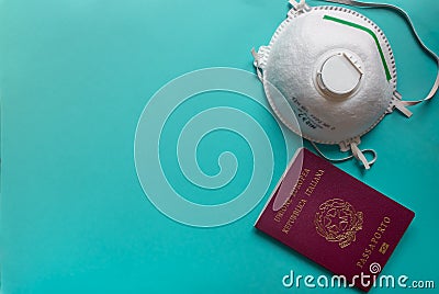 Concept of travelling in time of coronavirus pandemic: medical mask ffp3 ffp2 and passport on a blue backgound Editorial Stock Photo