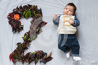 The concept of a two month old baby. Close up portrait of 2 months baby eye contact pink rose gold. figure 2 Stock Photo