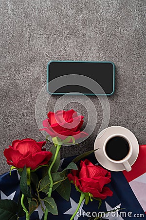 Concept of Independence day or Memorial day with smart phone and coffee. Flag over dark gray table background Stock Photo