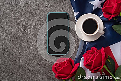 Concept of Independence day or Memorial day with smart phone and coffee. Flag over dark gray table background Stock Photo