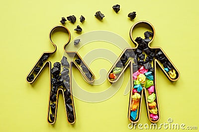 Concept of unhealthy communication, negative emotions and toxicity. Two figures with black and colored paper balls. Stock Photo