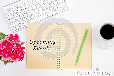 Concept Upcoming Events message on notebook with keyboard, pencil and coffee cup on white background. Stock Photo