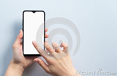 Concept of use of the smartphone. A smartphone with a white blank screen in the hand of a woman Stock Photo