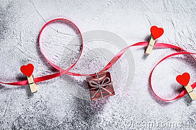 The concept of Valentine day. Gift box with red ribbon and hearts. Gray background. Top view. Space for text Stock Photo