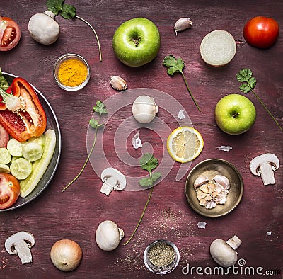 Concept of vegetarian food preparation of salad various vegetables and fruits pan rustic wooden background top view close up Stock Photo