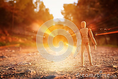 concept of vision and different thinking. wooden dummy standing on the road or path looking forward. Stock Photo
