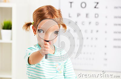 Concept vision testing. child girl with a magnifying glass Stock Photo