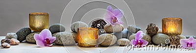 Concept of wellbeing with pebbles, orchids and candles, panoramic Stock Photo