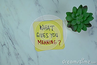 Concept of What Gives You Meaning? write on sticky notes isolated on Wooden Table Stock Photo