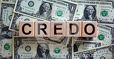 Concept word `credo` on cubes on a beautiful background from dollar bills. Business concept Stock Photo