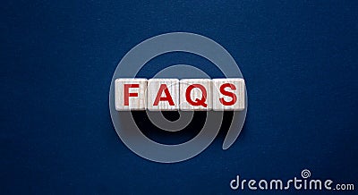 Concept word `FAQS` on cubes on a beautiful black background. Business concept, copy space Stock Photo