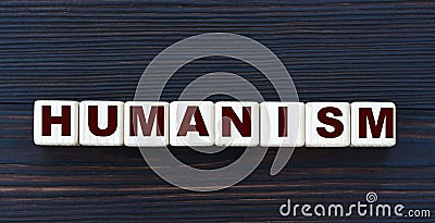 Concept word HUMANISM on cubes on a beautiful dark wooden background Stock Photo