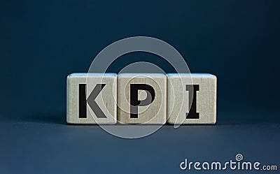 Concept word `KPI - key perfomance indicator` on cubes on a beautiful grey background. Business concept. Copy space Stock Photo