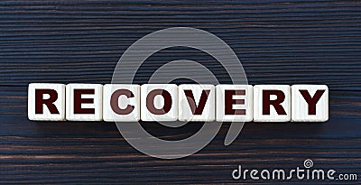 Concept word RECOVERY on cubes on a beautiful dark wooden background Stock Photo