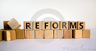 Concept word `reforms` on wooden cubes on a beautiful white background. Business concept. Copy space Stock Photo