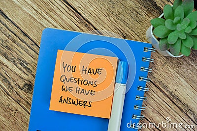 Concept of You Have Questions We Have Answers write on sticky notes isolated on Wooden Table Stock Photo