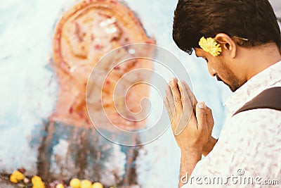 Concept of young Indian College Student prays before examination, results or interview in front of god at temple Stock Photo