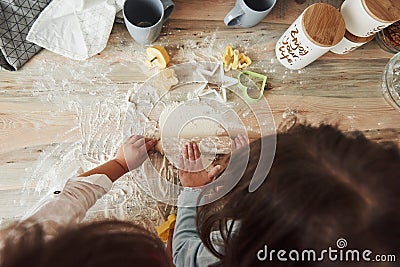 Conception of cooking. Top view of kids learning to prepare food from the flour with special formed instruments Stock Photo