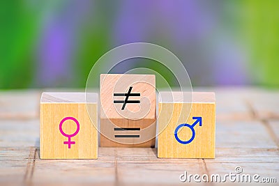 Concepts of gender equality. Wooden cube with symbol unequal change to equal sign Stock Photo