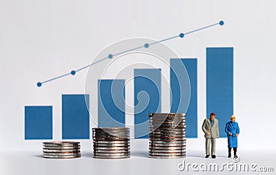 Blue bar graph with flow linear graph. The stack of coins and miniature older people. Stock Photo