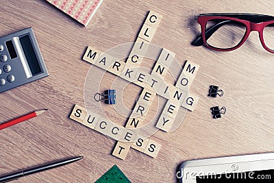 Conceptual business keywords on table with elements of game making crossword Stock Photo