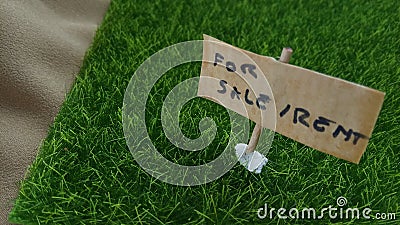 Conceptual Close up Element Design for Property, asset Advertising, for Rent or Sale, grass land with wooden plank with copy space Stock Photo