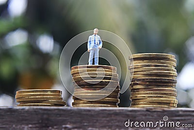 Conceptual Close Up Photo, Standing Man at Rupiah Golden Coin, ilustration for successful or wealth Stock Photo