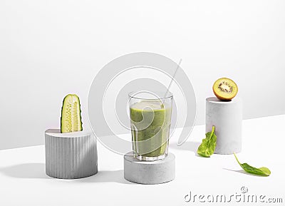 Conceptual creative still life with green fruits and smoothie on concrete podiums Stock Photo