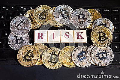 Conceptual cryptocurrency bitcoin on computer keyboard word Risk Stock Photo