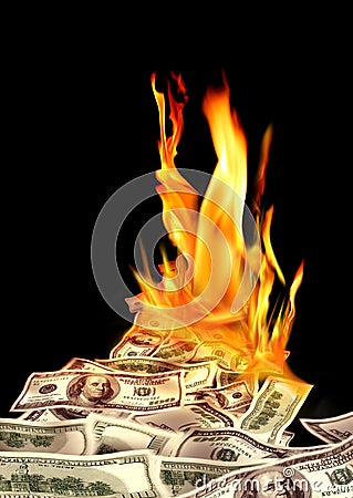 Conceptual finance image of burning pile of money, dollar bills, and fire flames in black background Stock Photo