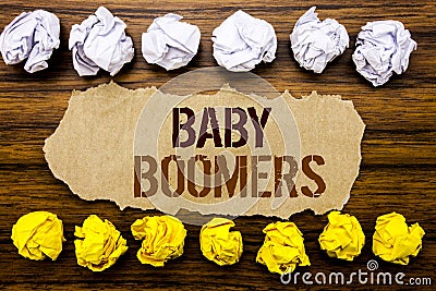 Conceptual hand text word Baby Boomers. Business concept for Demographic Generation Written on sticky note, wooden with sticky, ma Stock Photo
