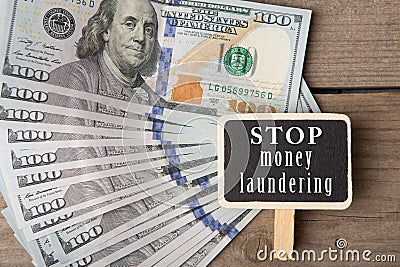 Conceptual image with blackboard with text & x22;stop money laundering& x22; and hundred dollar bills Stock Photo