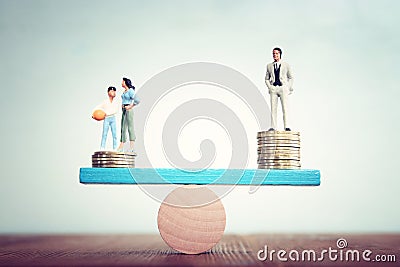 Conceptual image of gender inequality. A woman and a man on either side of the scales, with income difference Stock Photo