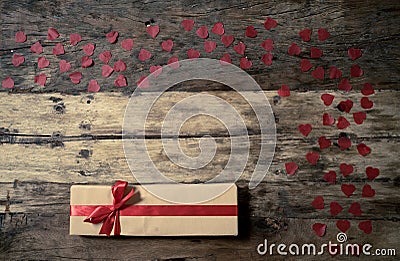 Conceptual image of Happy Saint valentines day wrapped gifts and red hearts on wooden vintage table Stock Photo