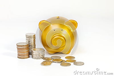 Pile of coins close gold piggy bank on white background. Stock Photo